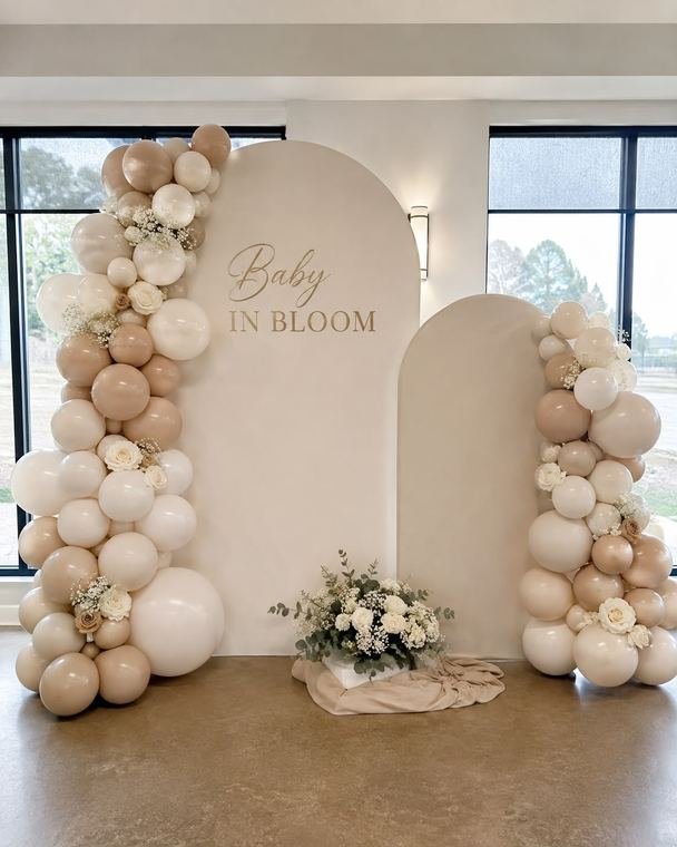 Baby in Bloom double arch backdrop with neutral balloon garlands and fresh florals