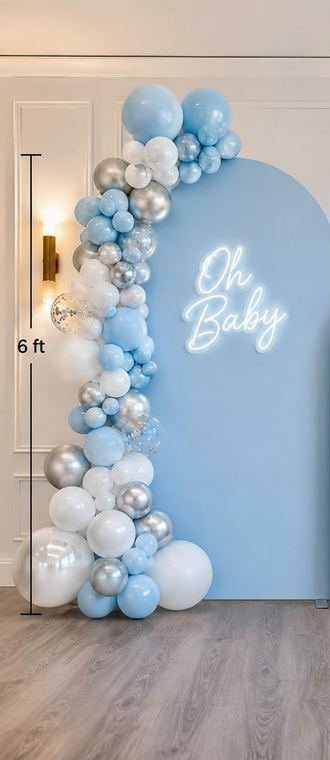 Six foot blue and silver balloon garland beside an Oh Baby neon sign