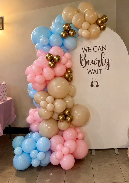 We Can Bearly Wait gender reveal backdrop with a pink, blue, tan and chrome gold balloon garland