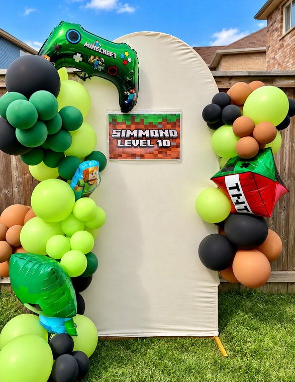 Minecraft themed tenth birthday backdrop set up outdoors in a backyard with green, black and brown balloons and character foil balloons